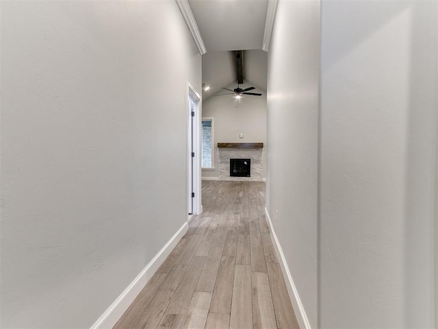 hall with crown molding, lofted ceiling with beams, and light hardwood / wood-style floors