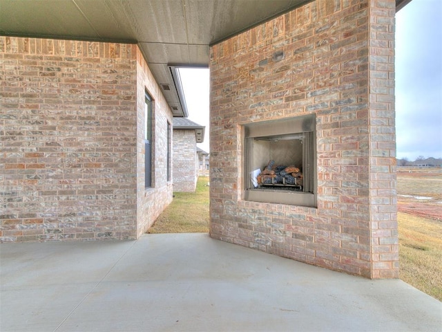 view of patio with exterior fireplace