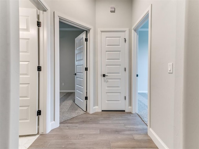 hallway with light colored carpet