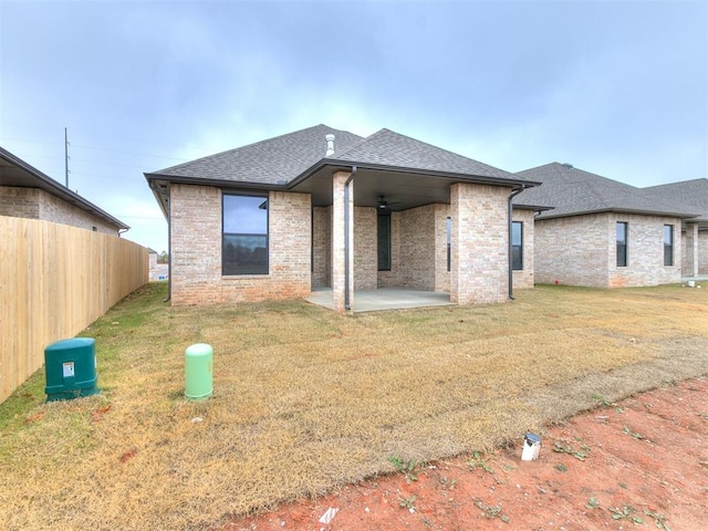 rear view of house with a lawn, ceiling fan, and a patio