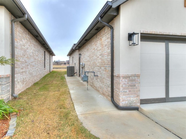 view of property exterior featuring a lawn and central AC