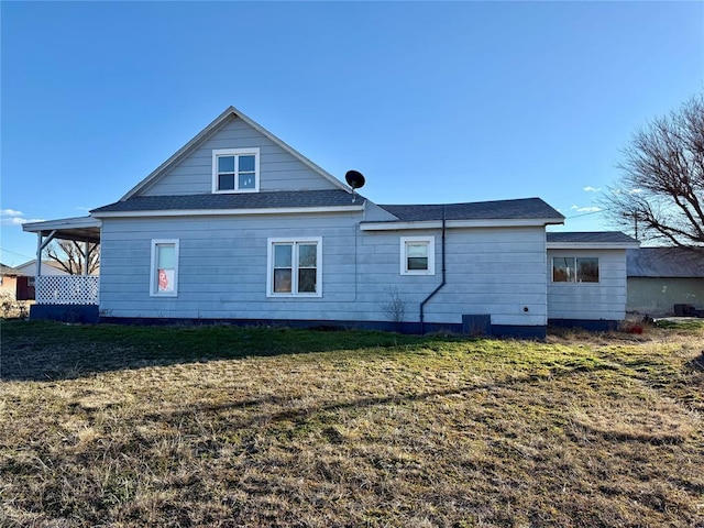 back of property featuring a lawn