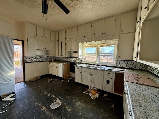 kitchen featuring decorative backsplash, a textured ceiling, ceiling fan, and sink