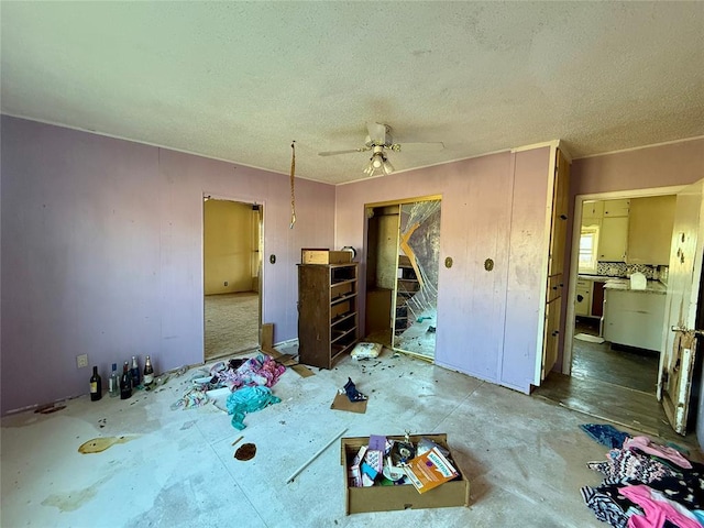 misc room featuring a textured ceiling and ceiling fan