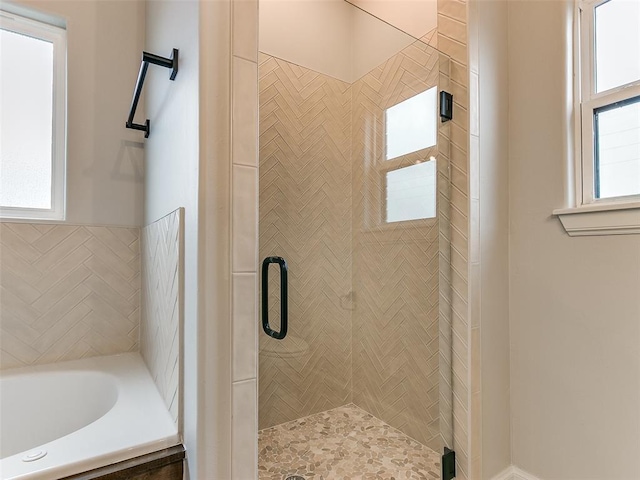 bathroom with shower with separate bathtub