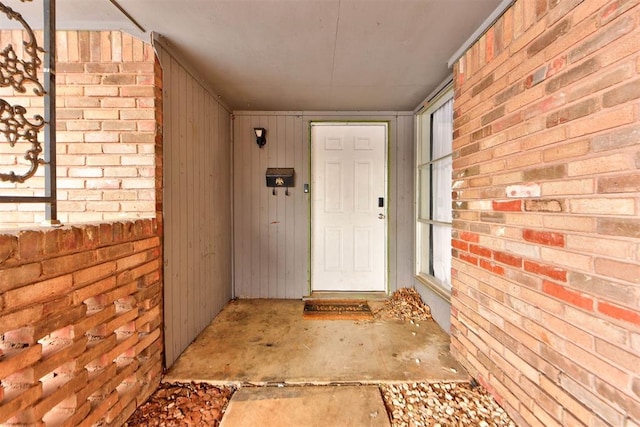 view of exterior entry with brick siding