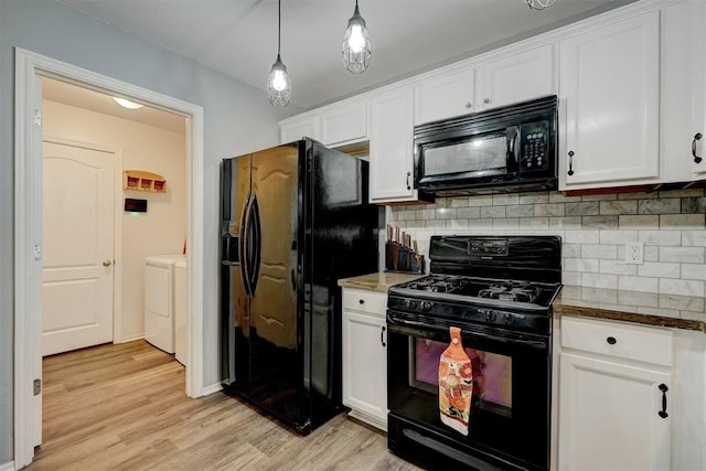 kitchen featuring washing machine and clothes dryer, white cabinetry, hanging light fixtures, backsplash, and black appliances