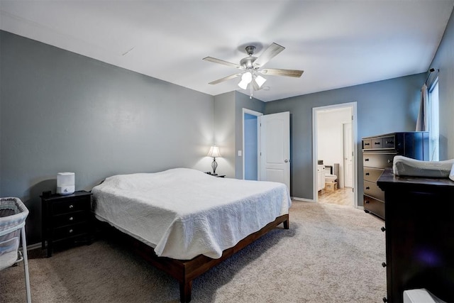 carpeted bedroom featuring ensuite bath and ceiling fan