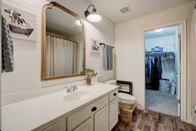 bathroom featuring vanity, hardwood / wood-style flooring, and toilet