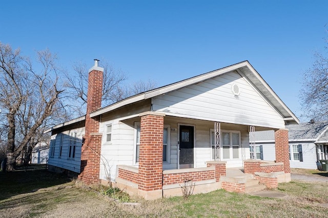 bungalow-style home with a porch and a front yard