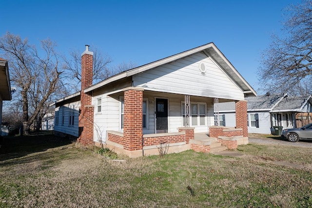 bungalow-style house with a front lawn and a porch