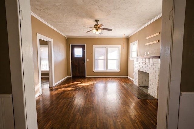 unfurnished living room featuring ceiling fan, a fireplace, crown molding, and a textured ceiling