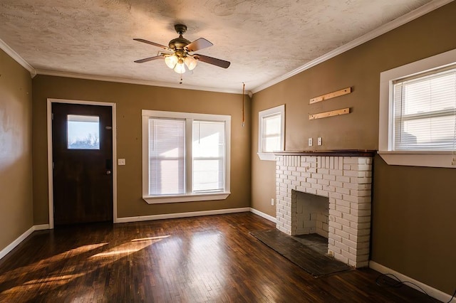 unfurnished living room featuring a fireplace, a textured ceiling, plenty of natural light, and crown molding