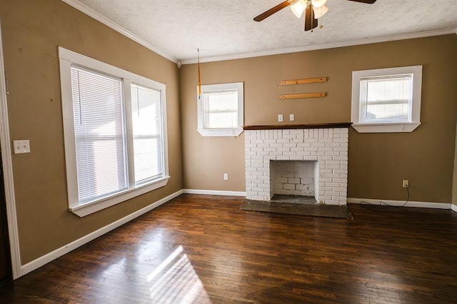 unfurnished living room with crown molding, plenty of natural light, ceiling fan, and a brick fireplace