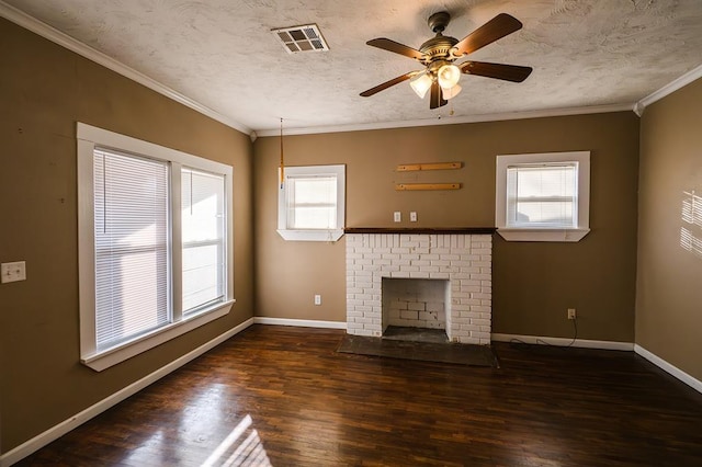 unfurnished living room featuring a textured ceiling, a brick fireplace, ceiling fan, and ornamental molding