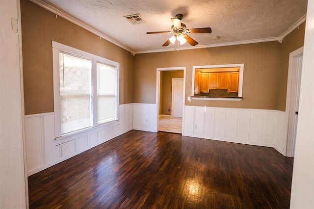 unfurnished living room with dark hardwood / wood-style flooring, ceiling fan, and crown molding