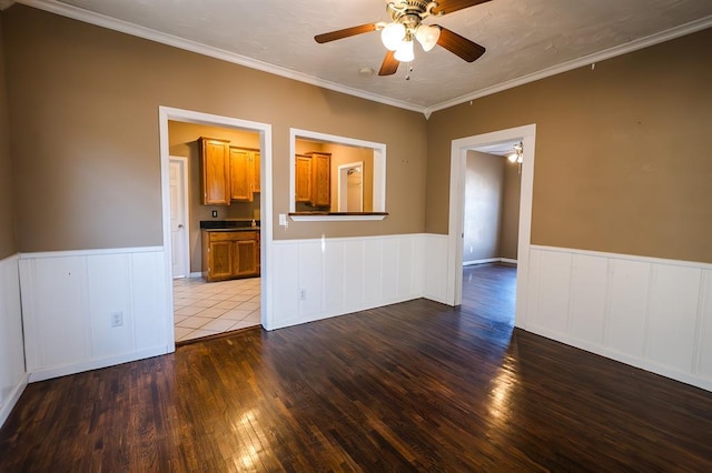 empty room featuring hardwood / wood-style floors, ceiling fan, and crown molding