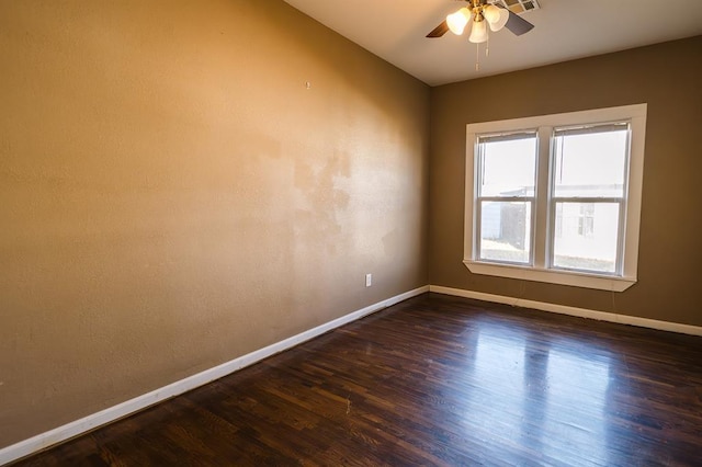 spare room with ceiling fan, dark wood-type flooring, and lofted ceiling