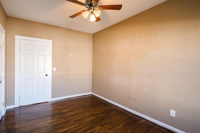 spare room featuring ceiling fan and dark hardwood / wood-style flooring