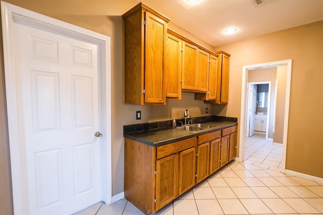 kitchen with sink and light tile patterned floors