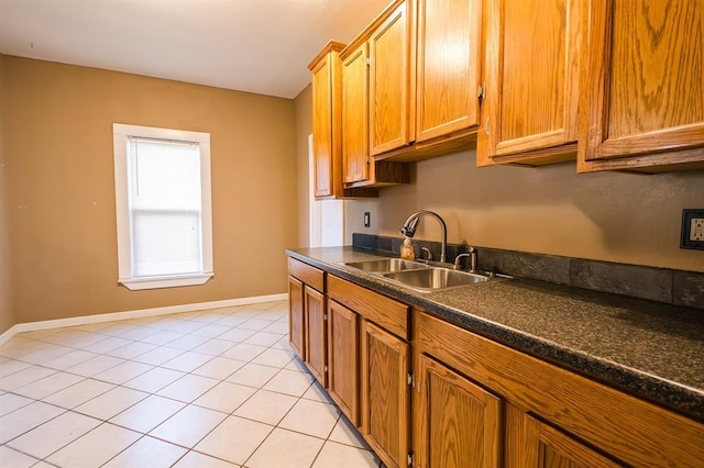 kitchen with light tile patterned floors and sink