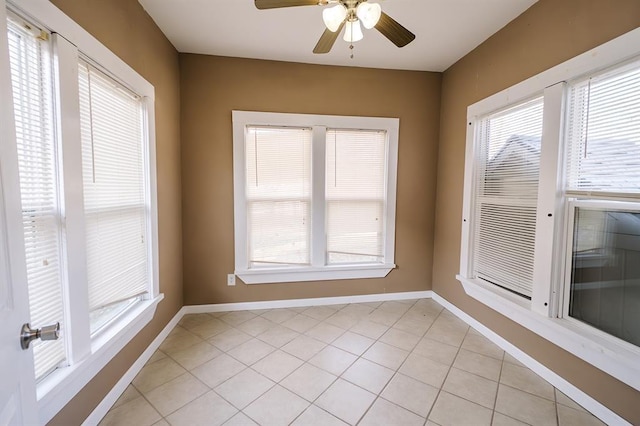 empty room with ceiling fan and light tile patterned flooring