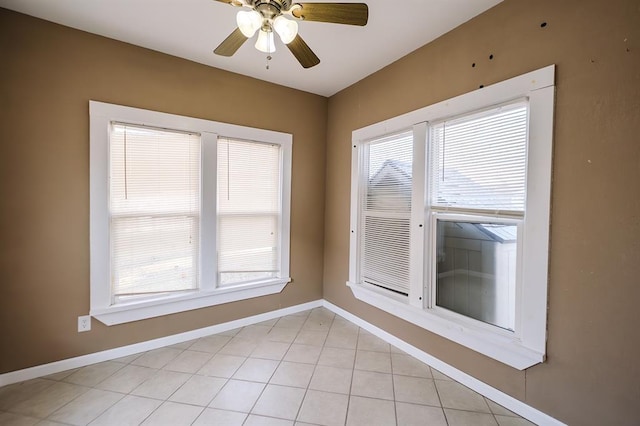 empty room featuring ceiling fan and light tile patterned flooring