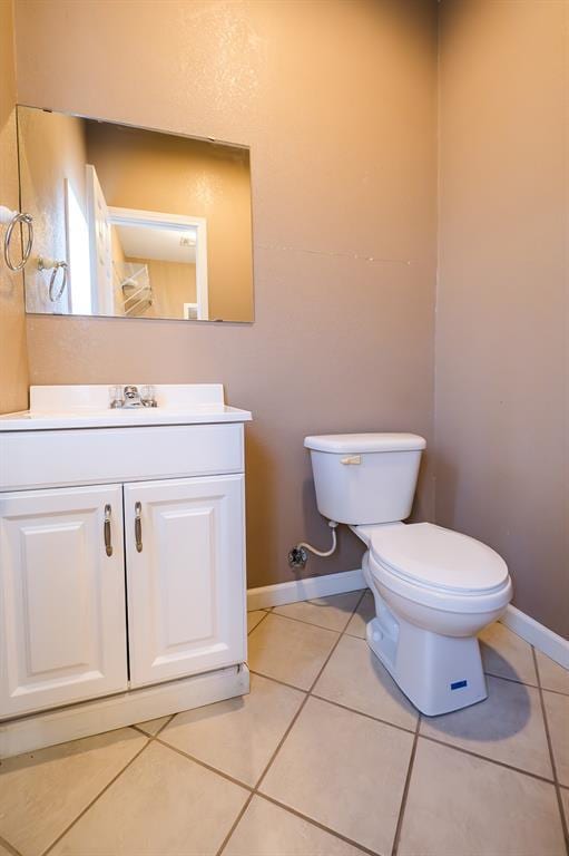 bathroom featuring tile patterned floors, vanity, and toilet