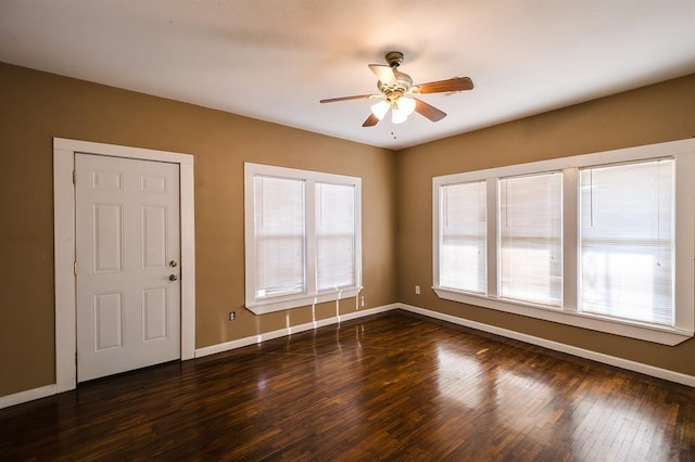 spare room with ceiling fan and dark wood-type flooring