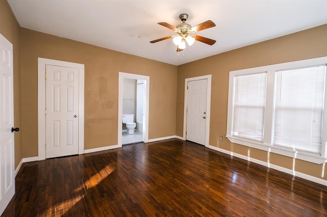 spare room featuring ceiling fan and dark wood-type flooring