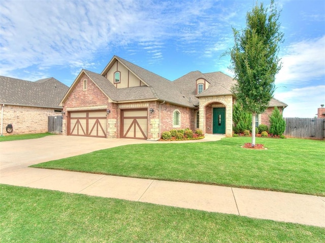 view of front of property with a front yard and a garage