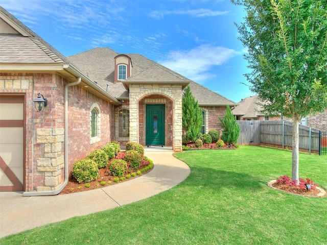 view of front of property with a garage and a front lawn