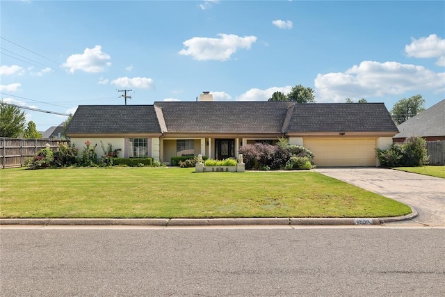 single story home featuring a front lawn and a garage