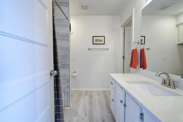 bathroom featuring vanity and hardwood / wood-style flooring