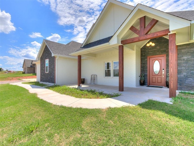 exterior space featuring covered porch and a front lawn