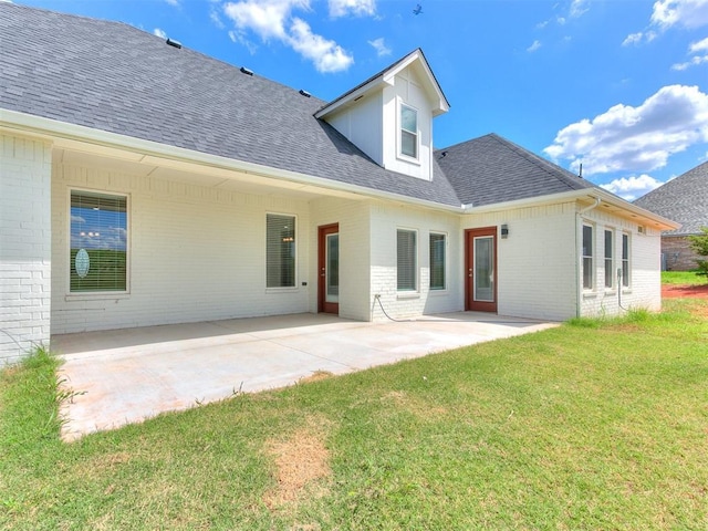 back of house with a yard and a patio