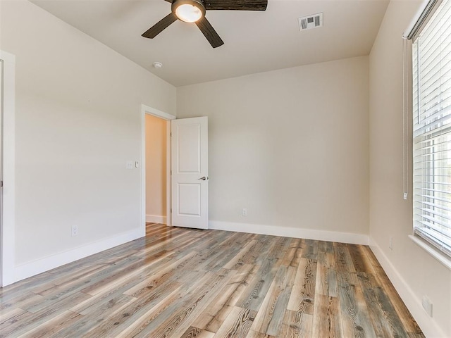 empty room featuring ceiling fan and light hardwood / wood-style floors