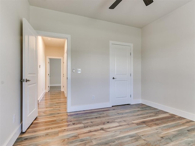 unfurnished bedroom featuring ceiling fan and light hardwood / wood-style flooring