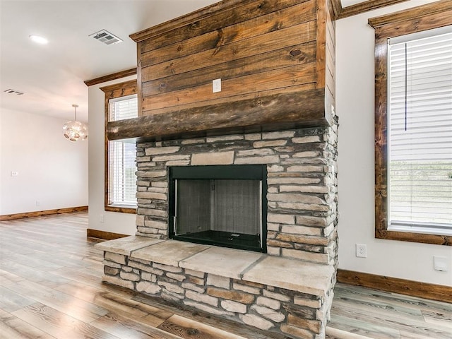 interior details with hardwood / wood-style floors, a notable chandelier, and a fireplace