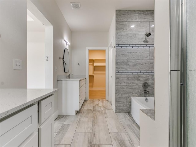 bathroom with vanity and independent shower and bath