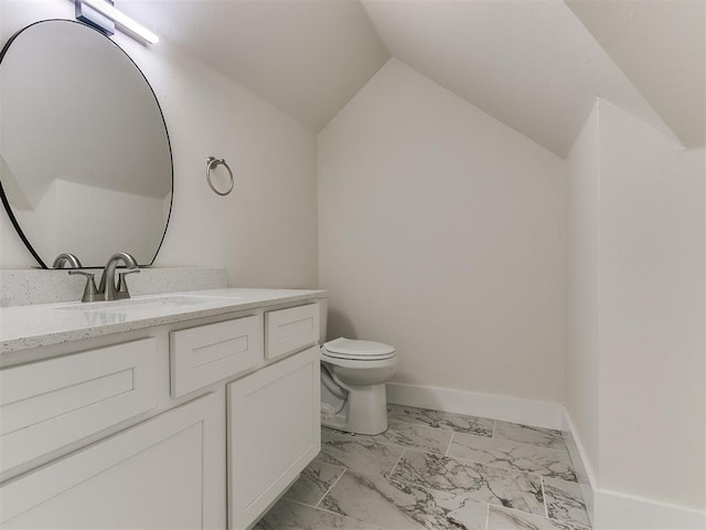 bathroom with vanity, vaulted ceiling, and toilet