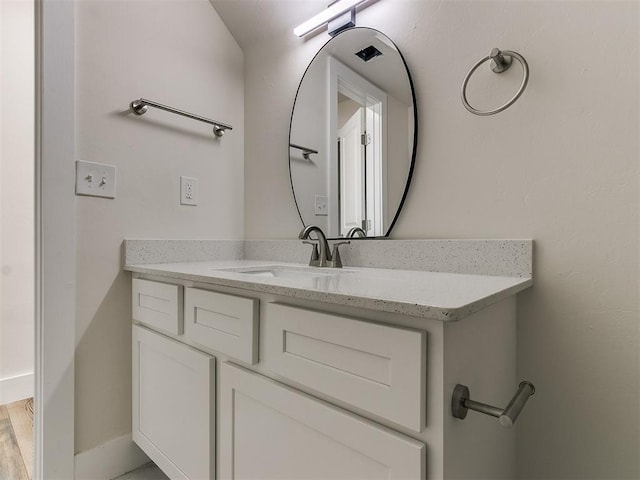 bathroom with vanity and wood-type flooring