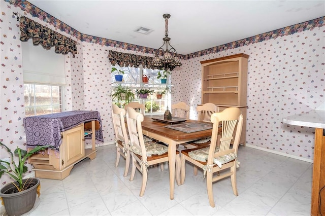 dining room featuring plenty of natural light and an inviting chandelier