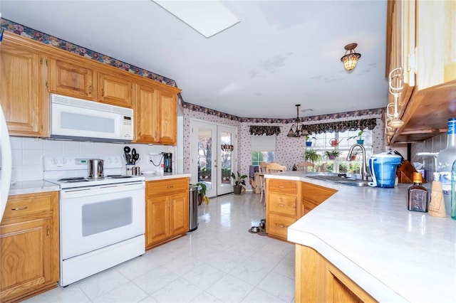 kitchen featuring french doors, sink, hanging light fixtures, and white appliances