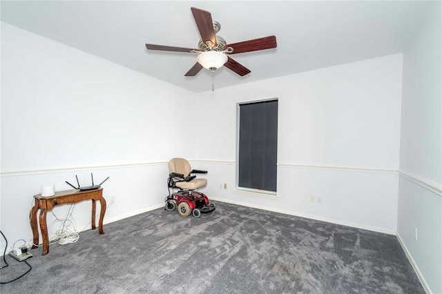 misc room with ceiling fan and dark colored carpet