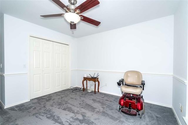 unfurnished room with dark carpet and ceiling fan