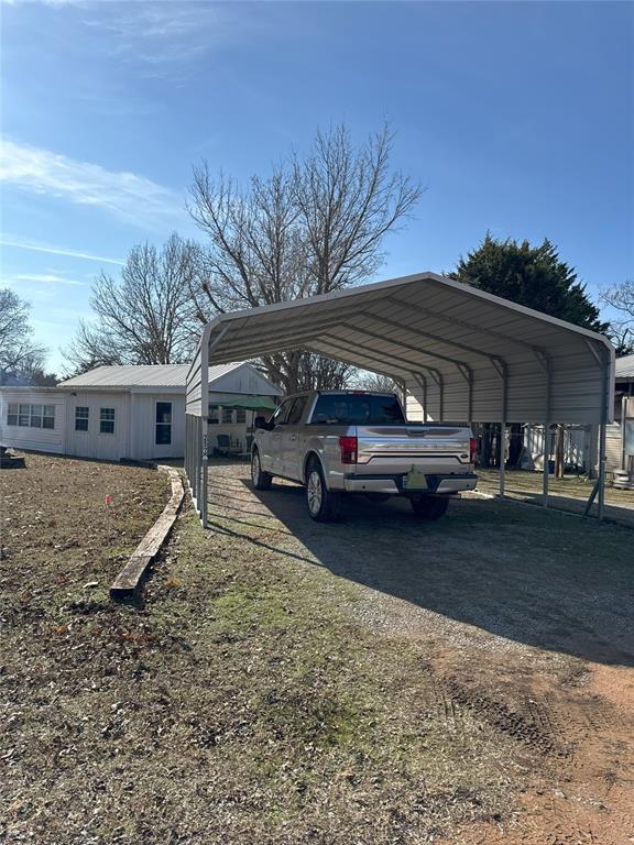 view of vehicle parking with a carport