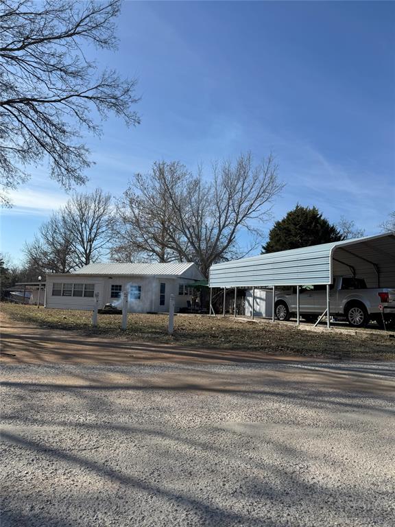 view of front of property featuring a carport