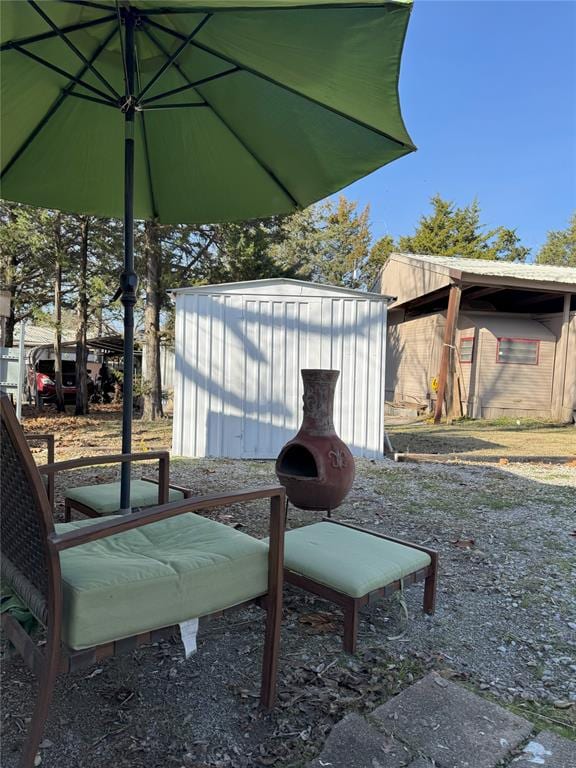 view of patio / terrace with a shed