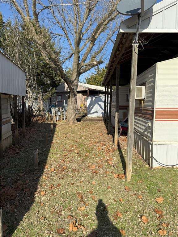 view of yard featuring an AC wall unit